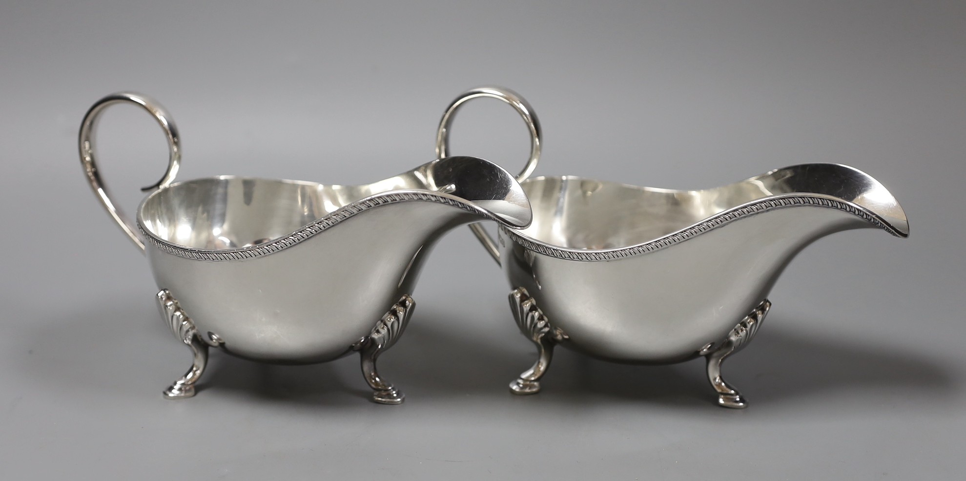 A pair of George V silver sauceboats, John Henry Potter, Sheffield 1930, length 19cm, 17oz.